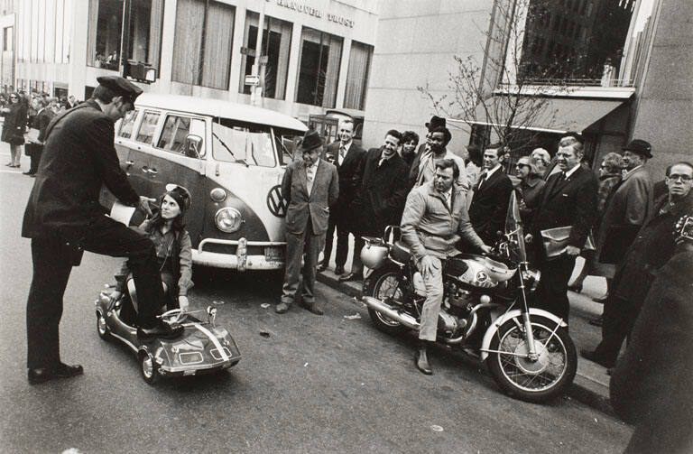 Fifth Avenue, NYC (Girl in miniature car with cop), from the portfolio Joel Meyerowitz Photographs, The Early Works