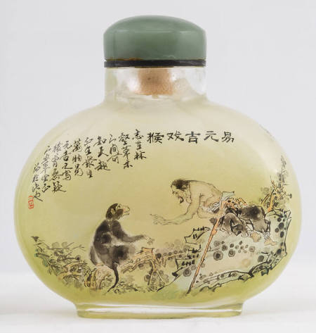 Snuff bottle with design of a man talking to a monkey